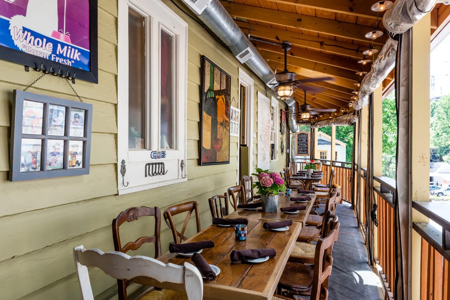 Charming restaurant patio with wooden tables and vibrant decor
