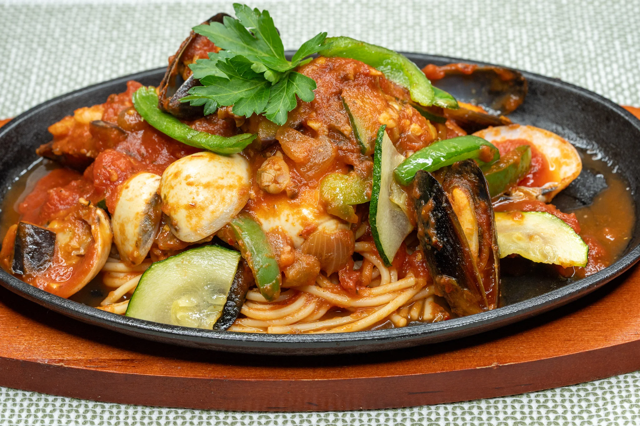 Seafood spaghetti marinara served on a sizzling platter