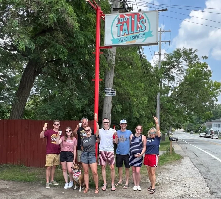 Group of friends outside Too Tall's Sweet & Savory restaurant