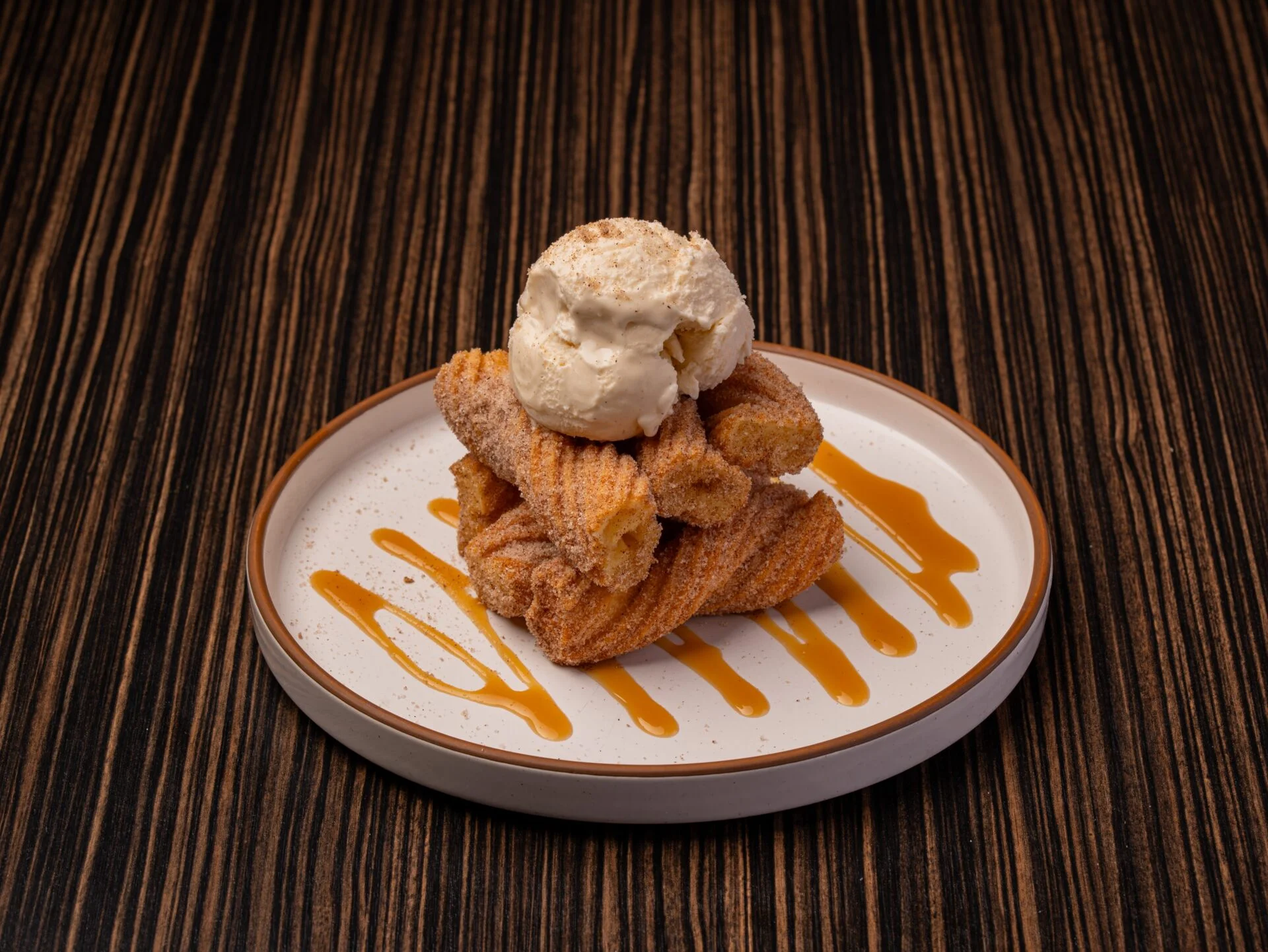 Churros with vanilla ice cream and caramel drizzle