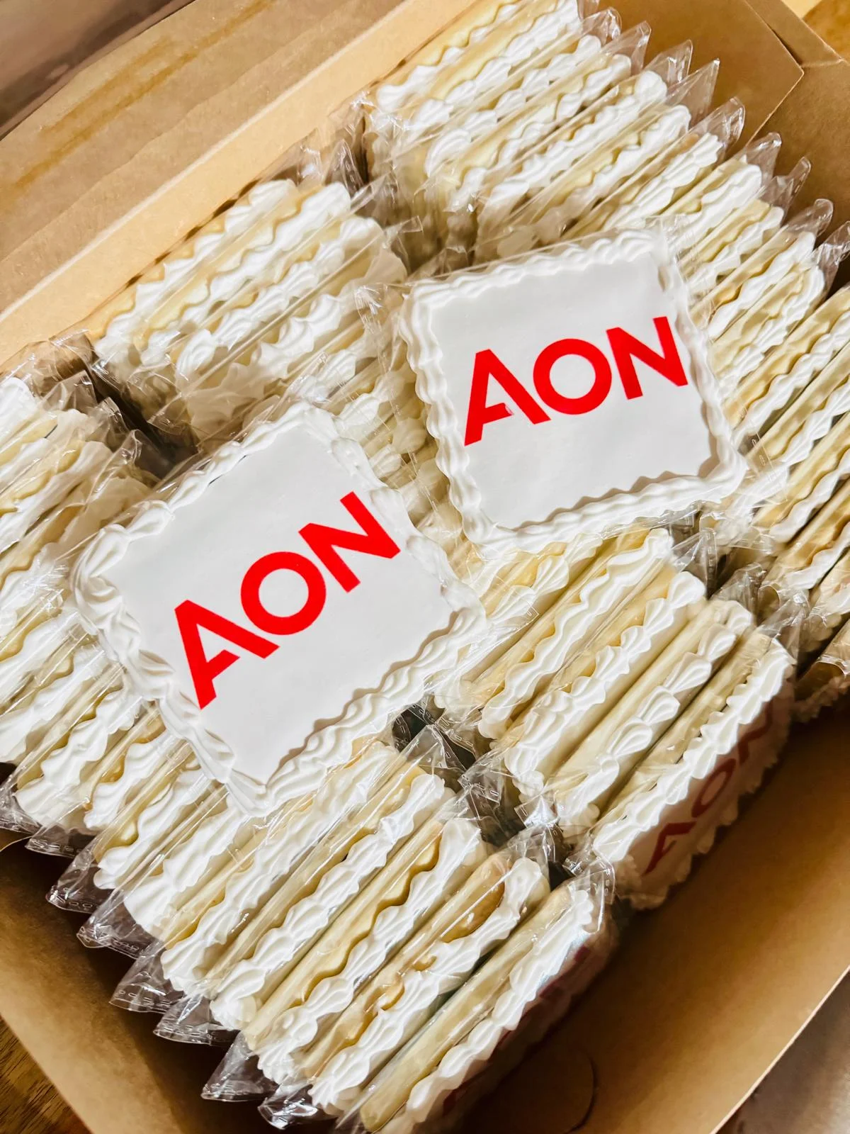 Decorative cookies with AON logo in a box