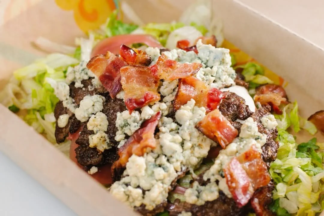 Bacon blue cheese burger on a bed of lettuce