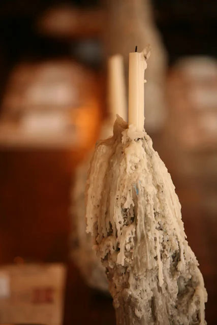 Artistic candle drippings in a cozy restaurant setting