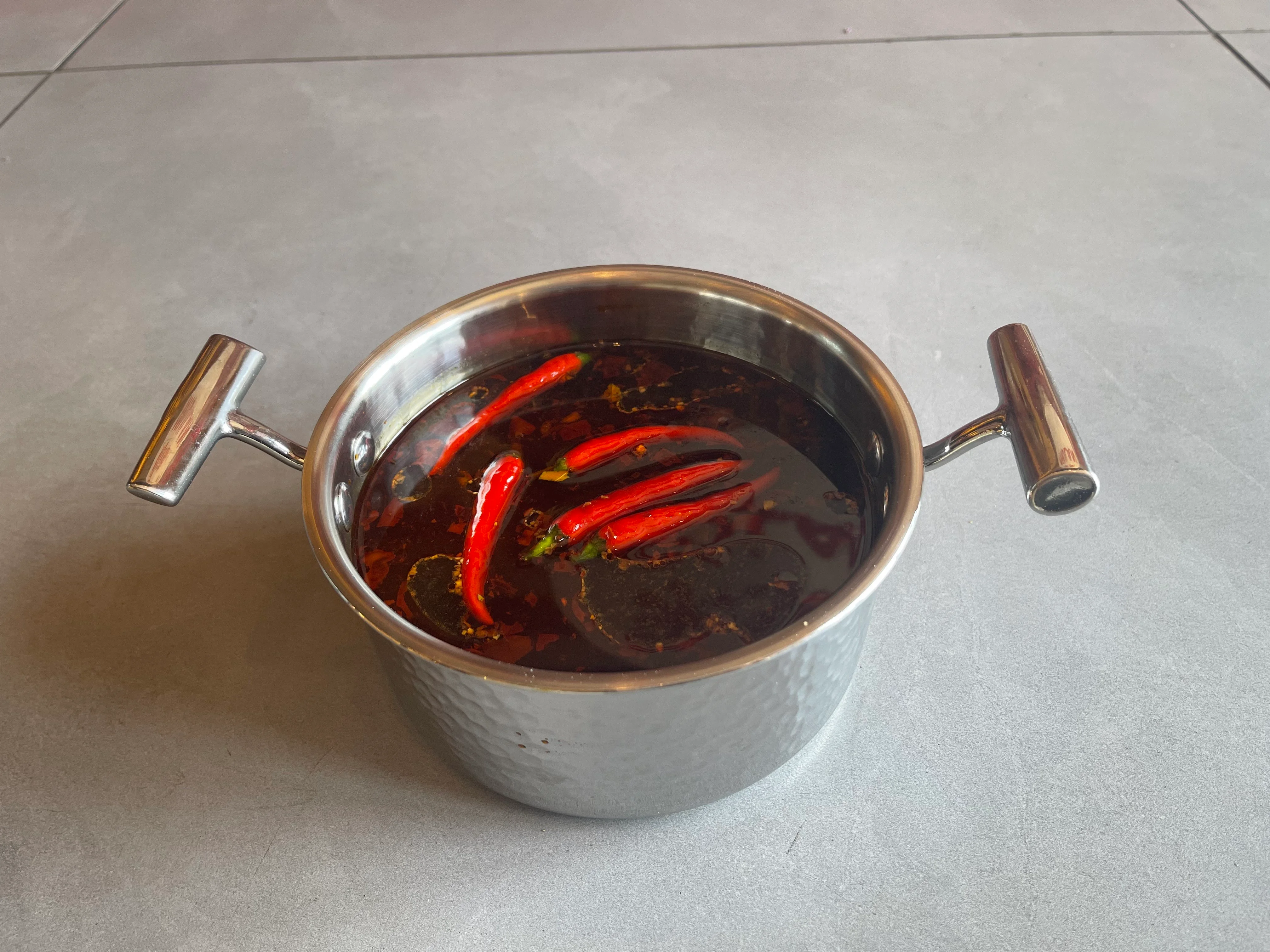 Spicy Sichuan chili oil in a stainless steel pot