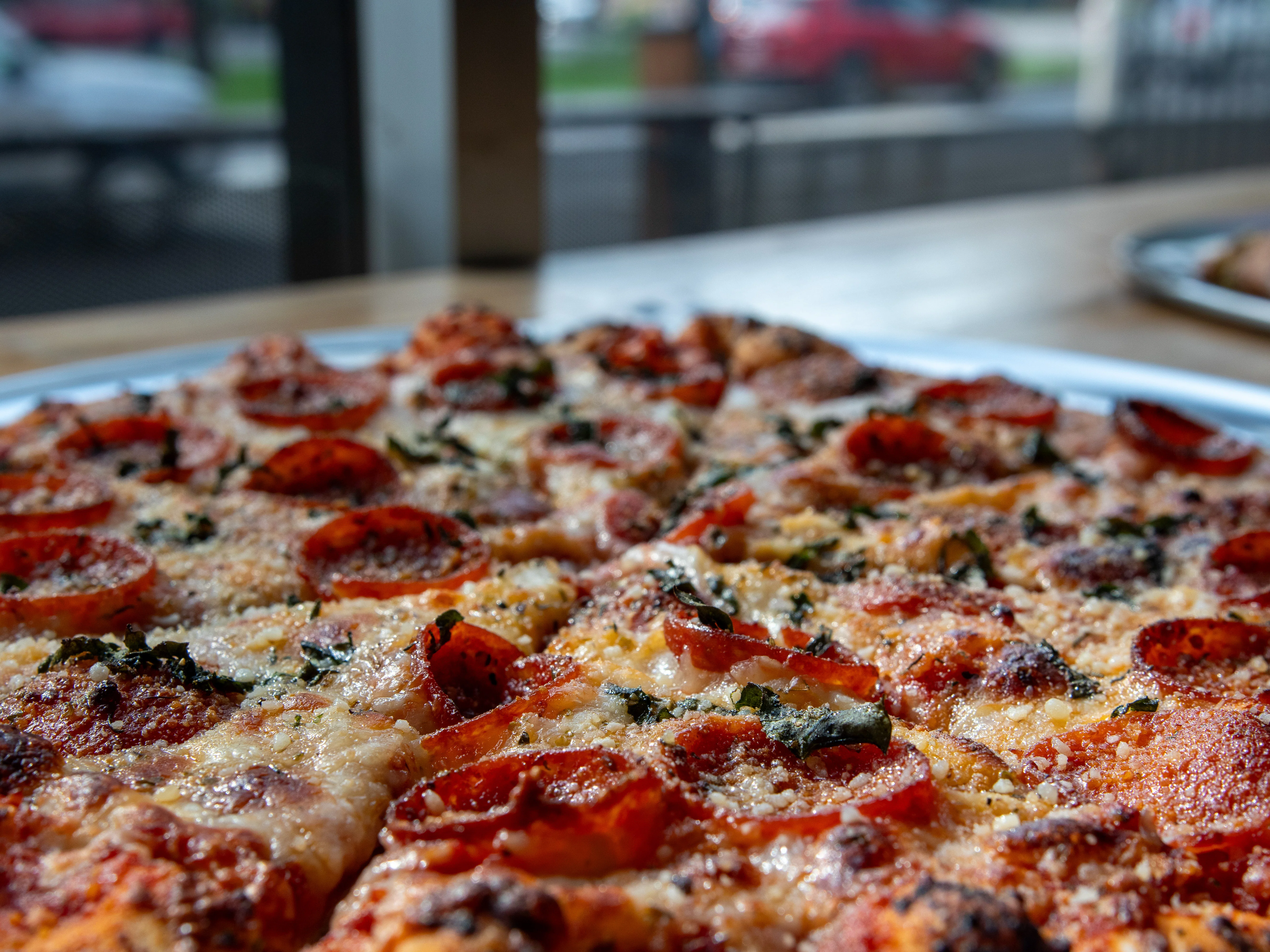 Pepperoni pizza with melted cheese and herbs