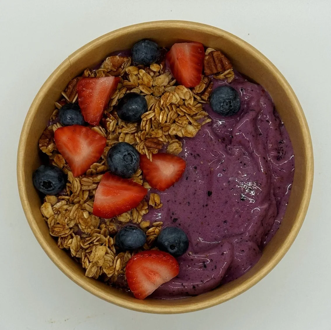 Acai bowl topped with granola and fresh berries