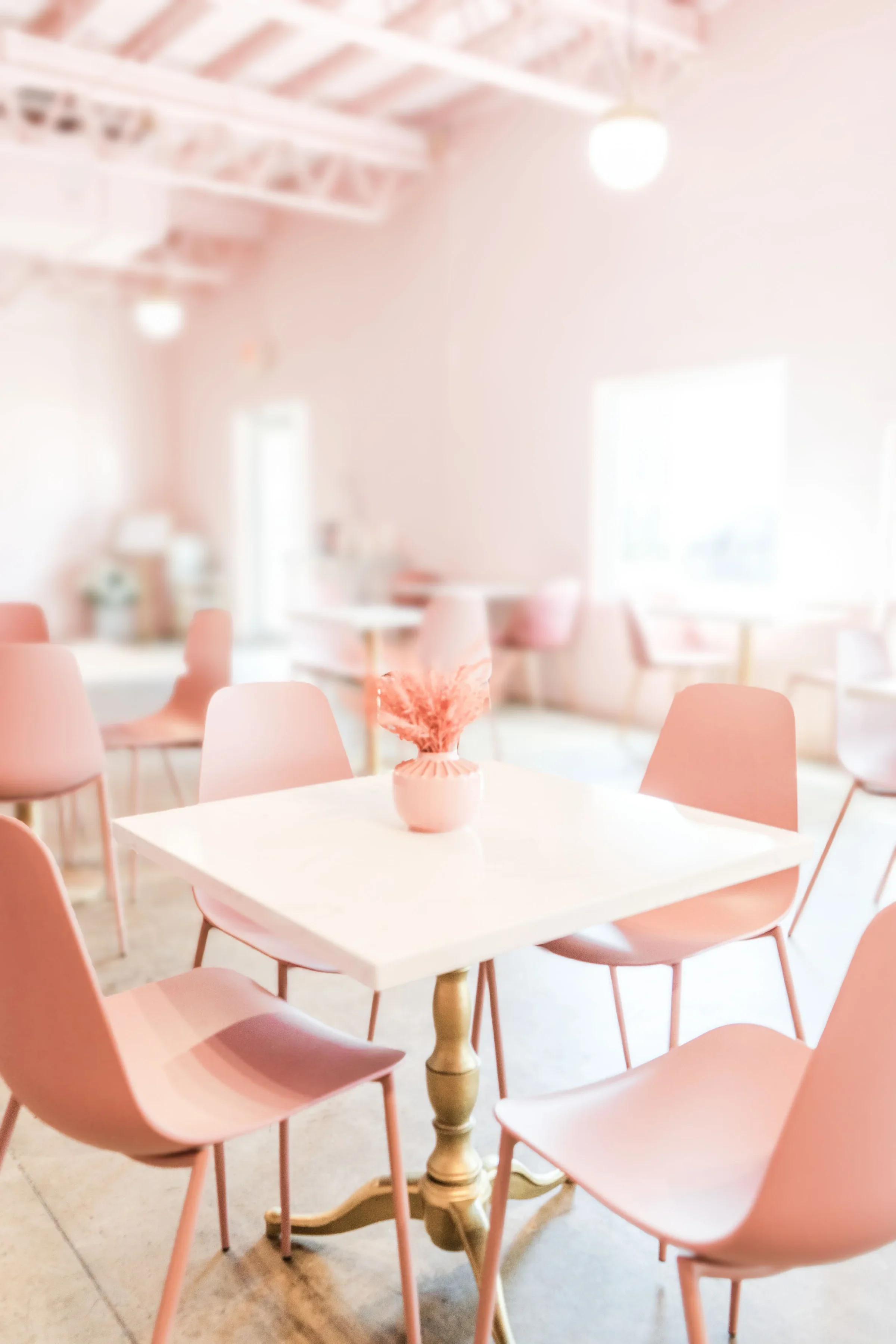 Chic restaurant interior with pink decor and modern furniture