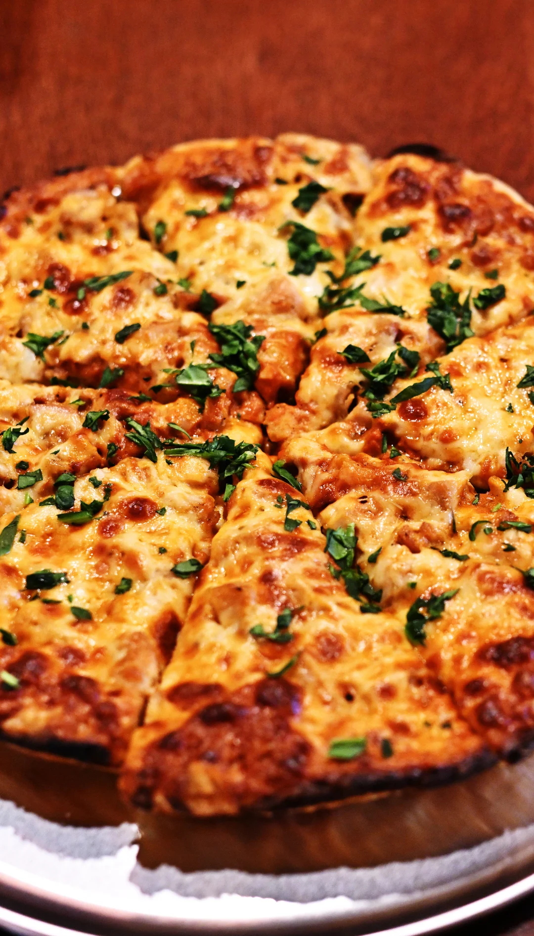 Cheesy pizza topped with fresh herbs