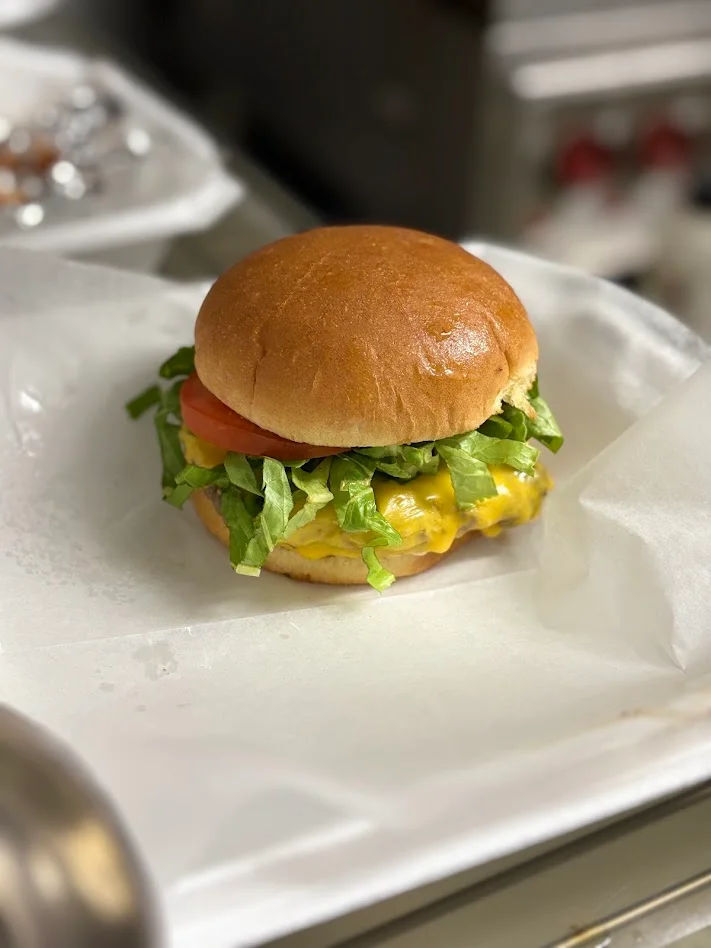 Classic Cheeseburger with lettuce and tomato on a brioche bun 