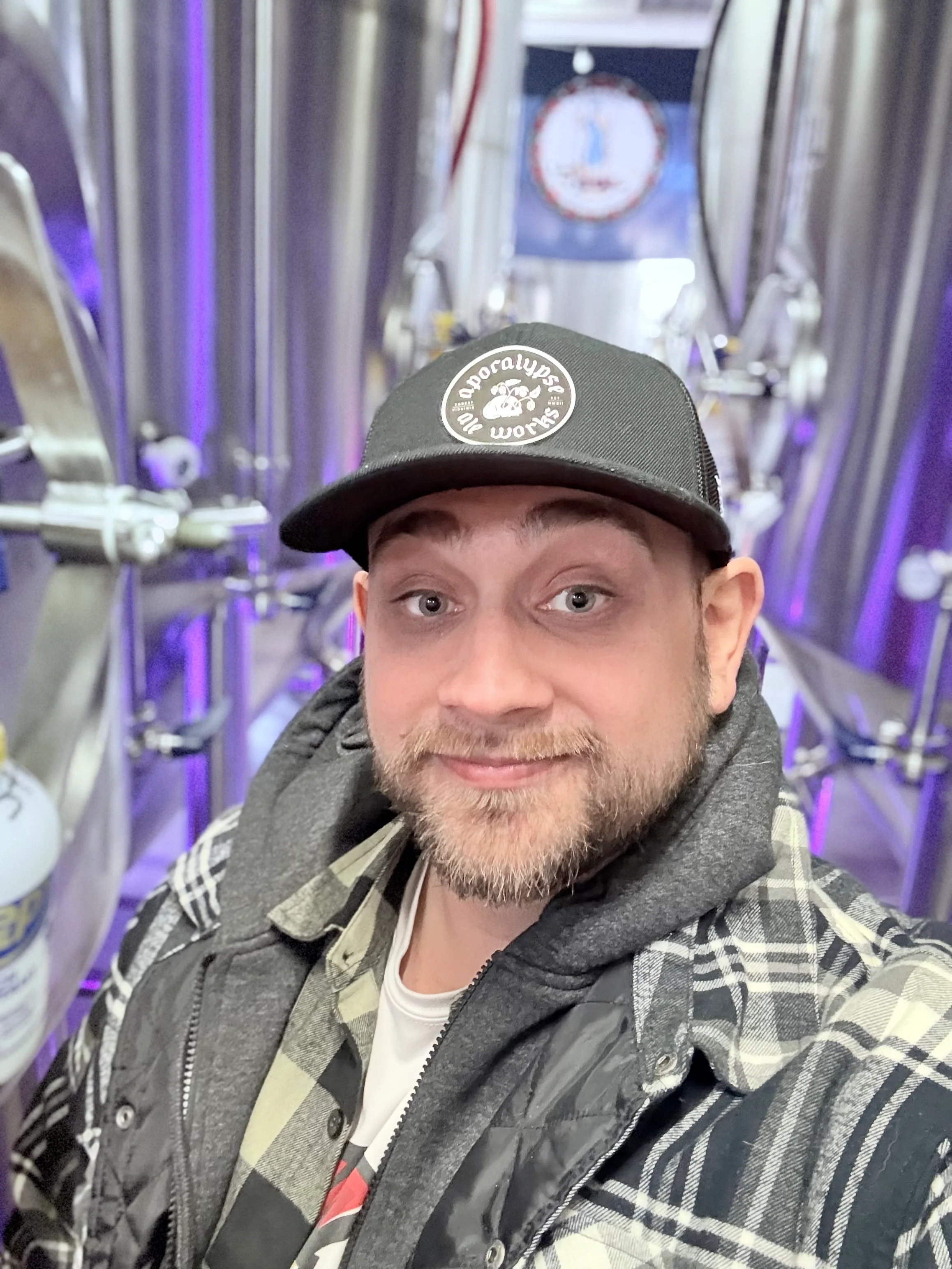 Brewery interior with stainless steel tanks and vibrant lighting