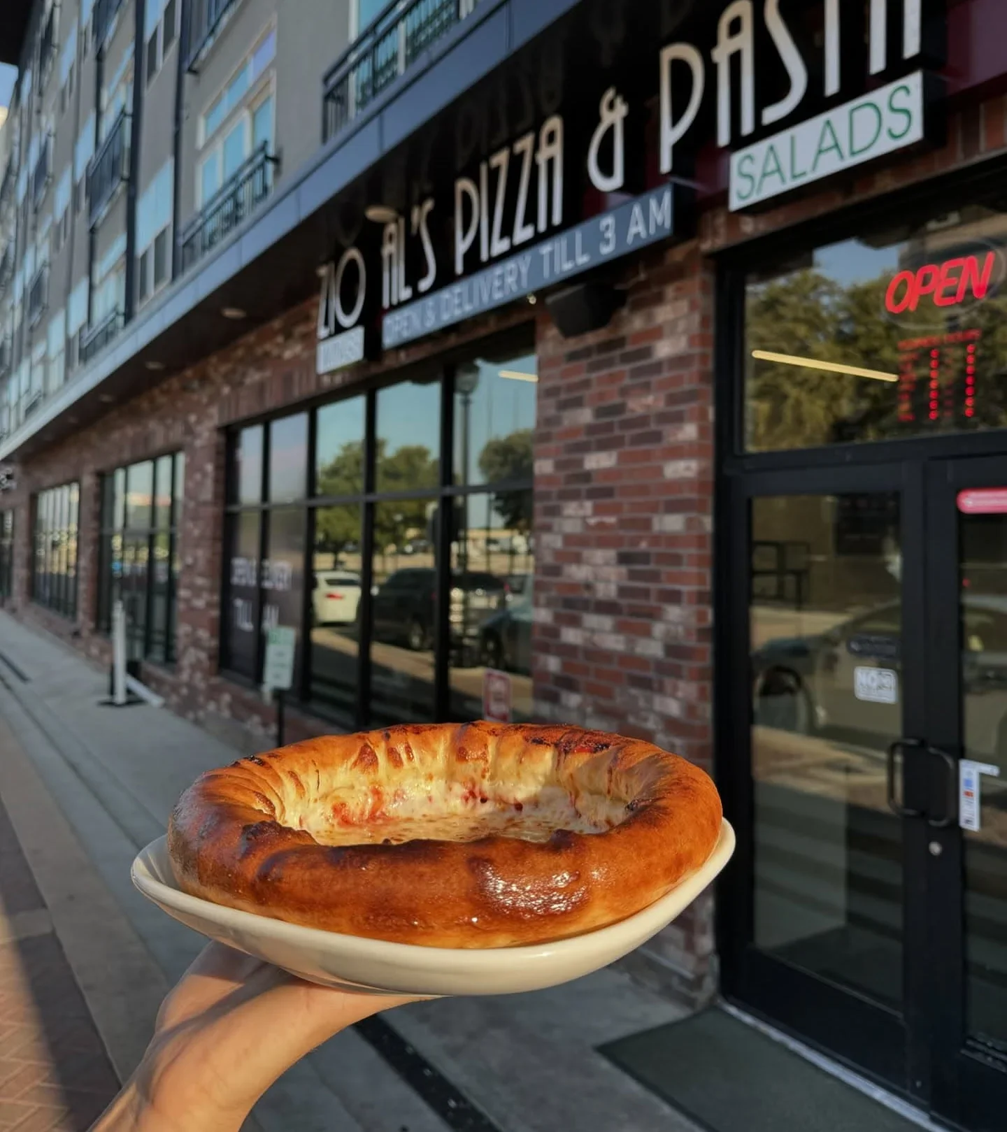 Cheesy calzone served outside a pizzeria