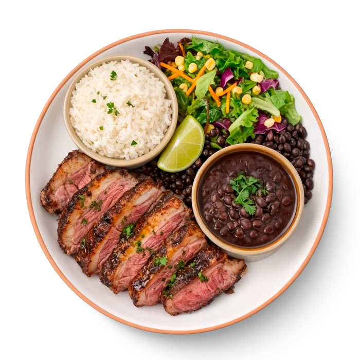 A colorful plate of picanha steak with sides of rice and vegetables.