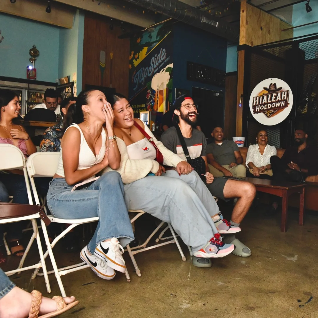 Lively audience enjoying a comedy show in a cozy venue