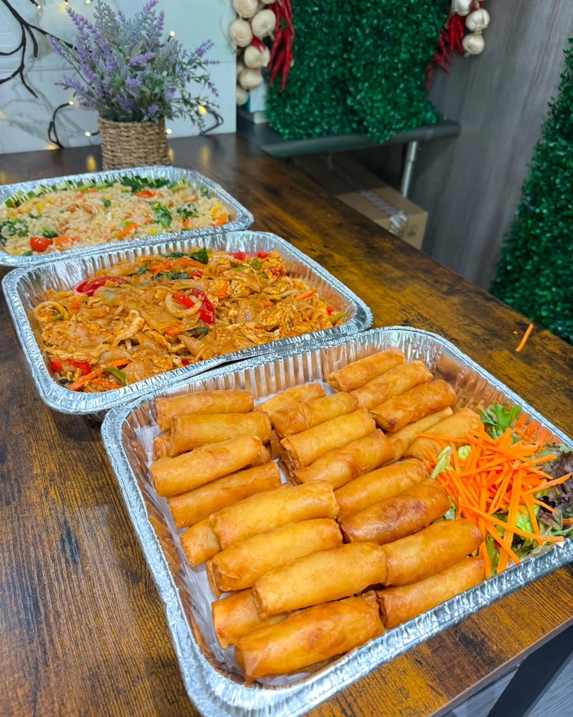 Assorted Asian dishes including spring rolls and stir-fried noodles