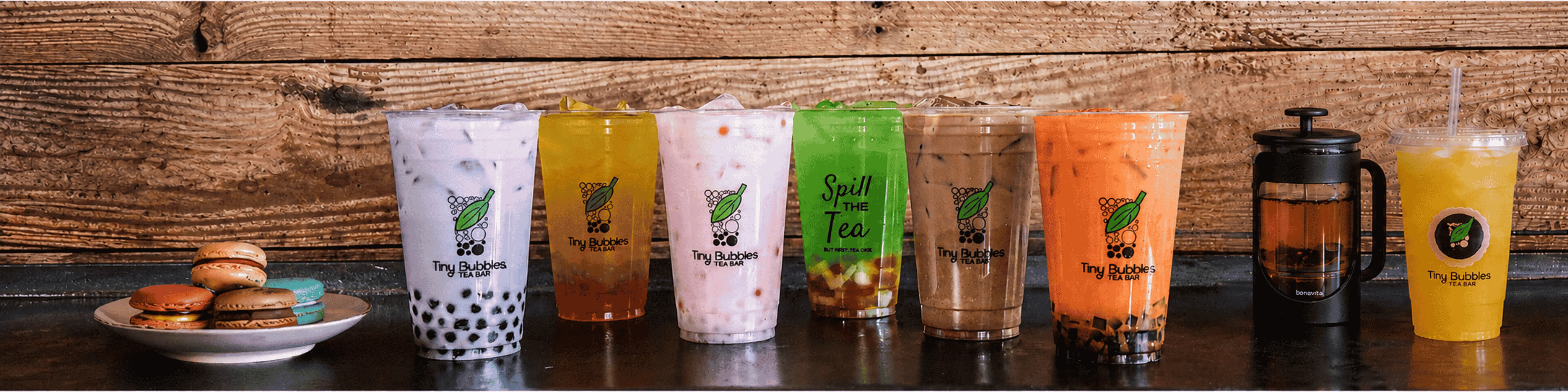 Colorful bubble tea drinks and macarons at a tea bar