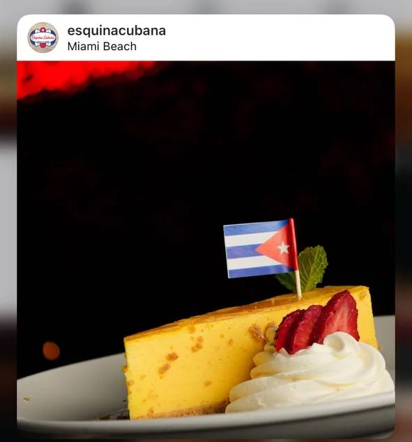 Cuban flan topped with a flag and fresh strawberries