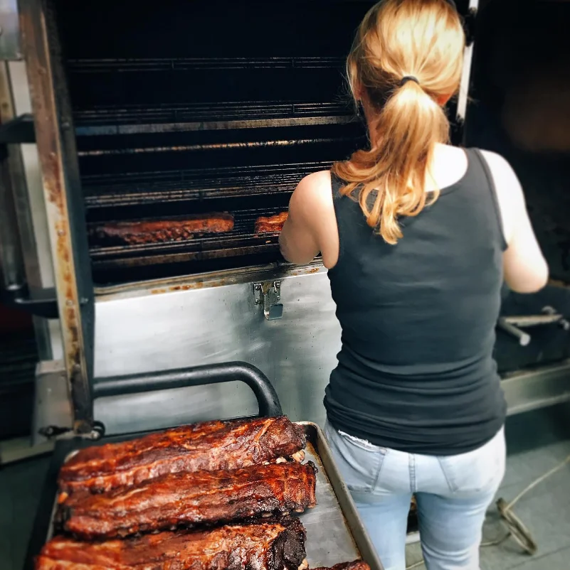 Barbecue ribs being smoked in a commercial kitchen