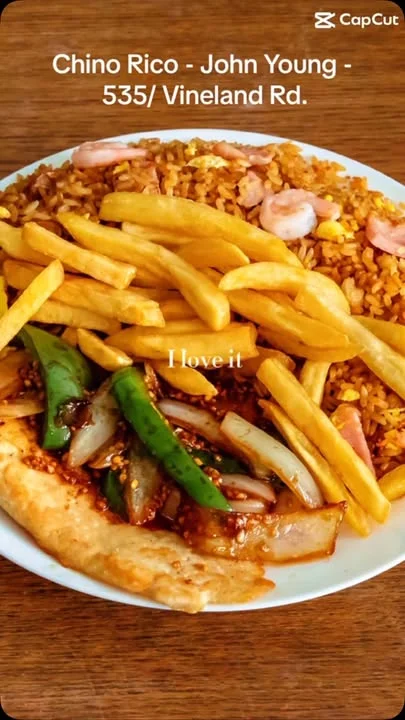Plate of Chinese fried rice with chicken and fries