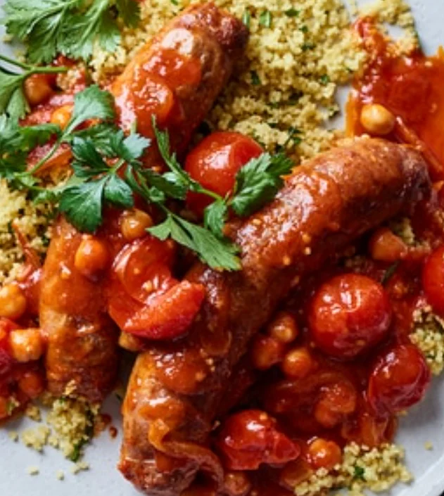 Delicious harissa lamb dish garnished with herbs and spices.