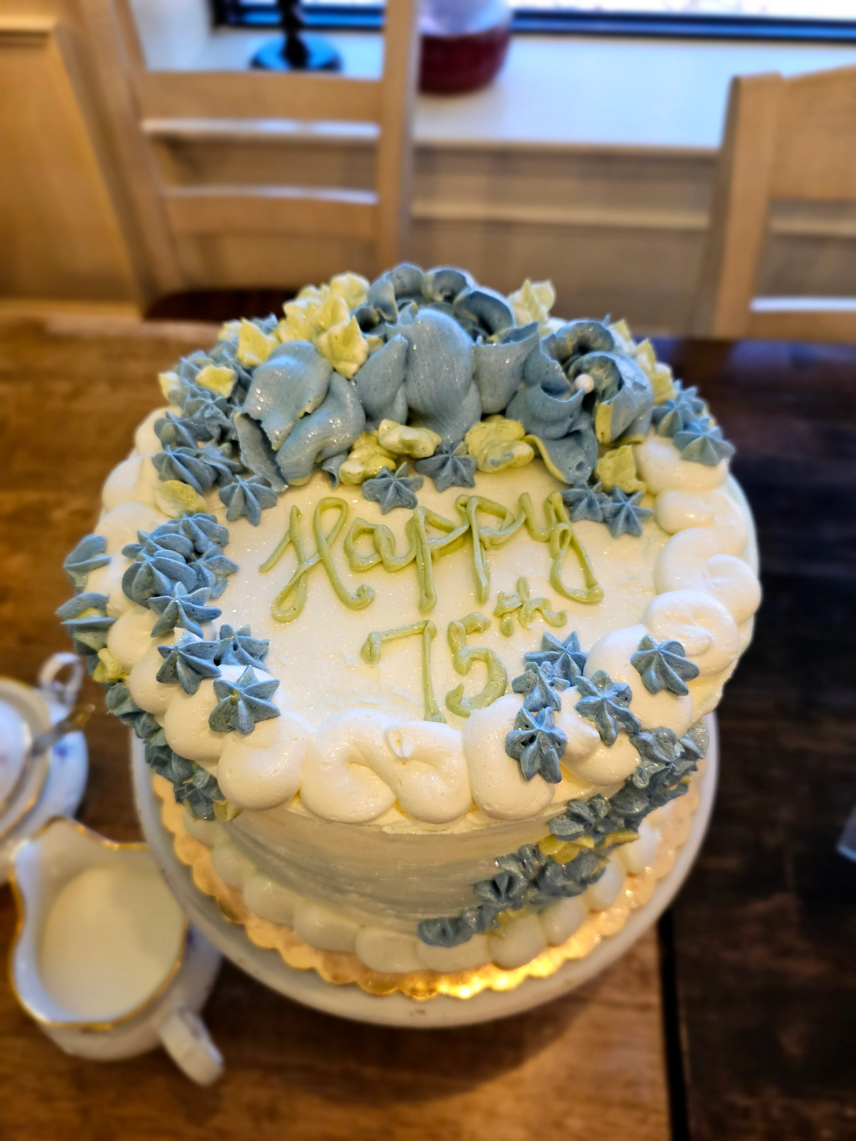 Elegant birthday cake decorated with blue and yellow frosting