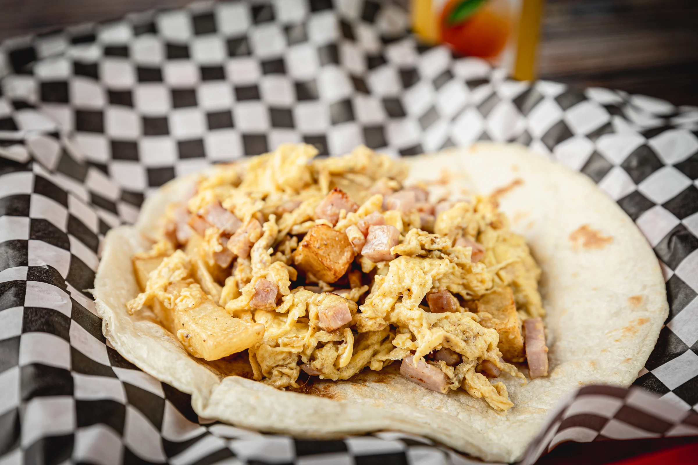 A ham, cheese, egg, and potato breakfast taco