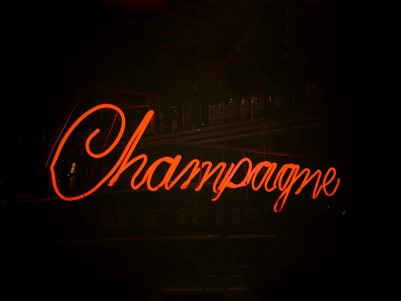 Neon sign displaying the word 'Champagne' in a bar setting