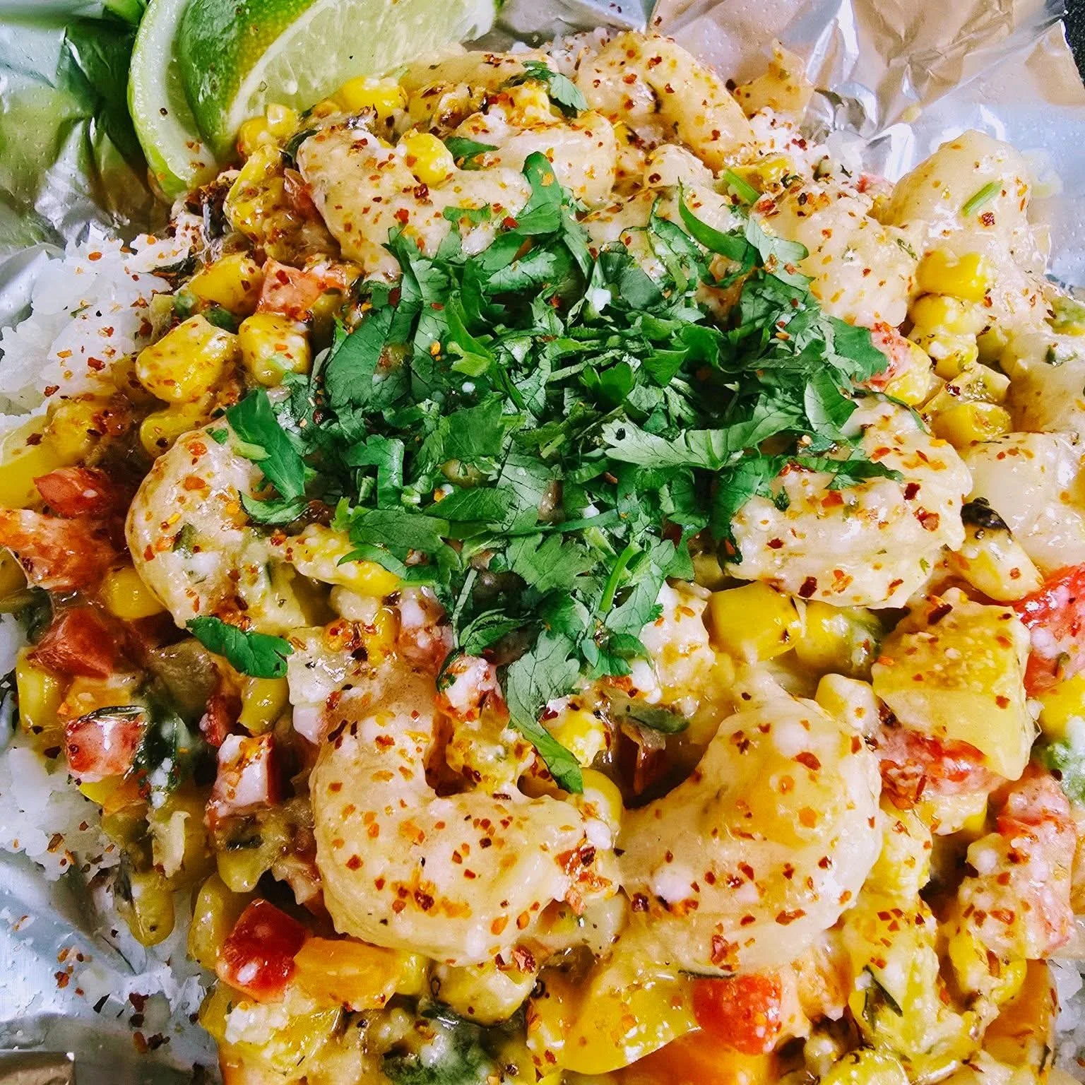 Shrimp ceviche with corn and cilantro in a foil wrap