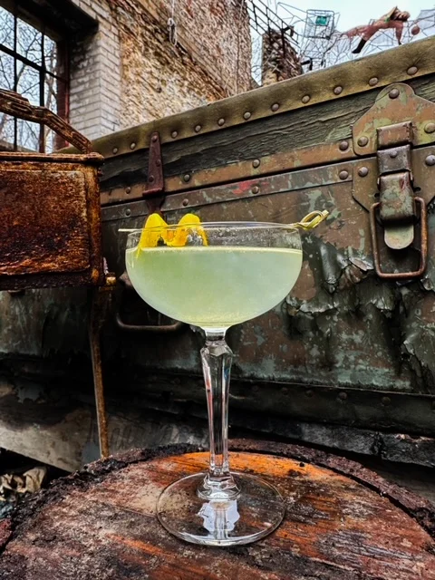 Craft cocktail with citrus twist in a rustic setting