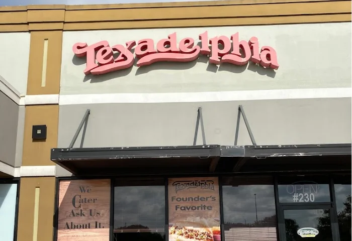 Exterior view of Texadelphia restaurant with signage and catering information