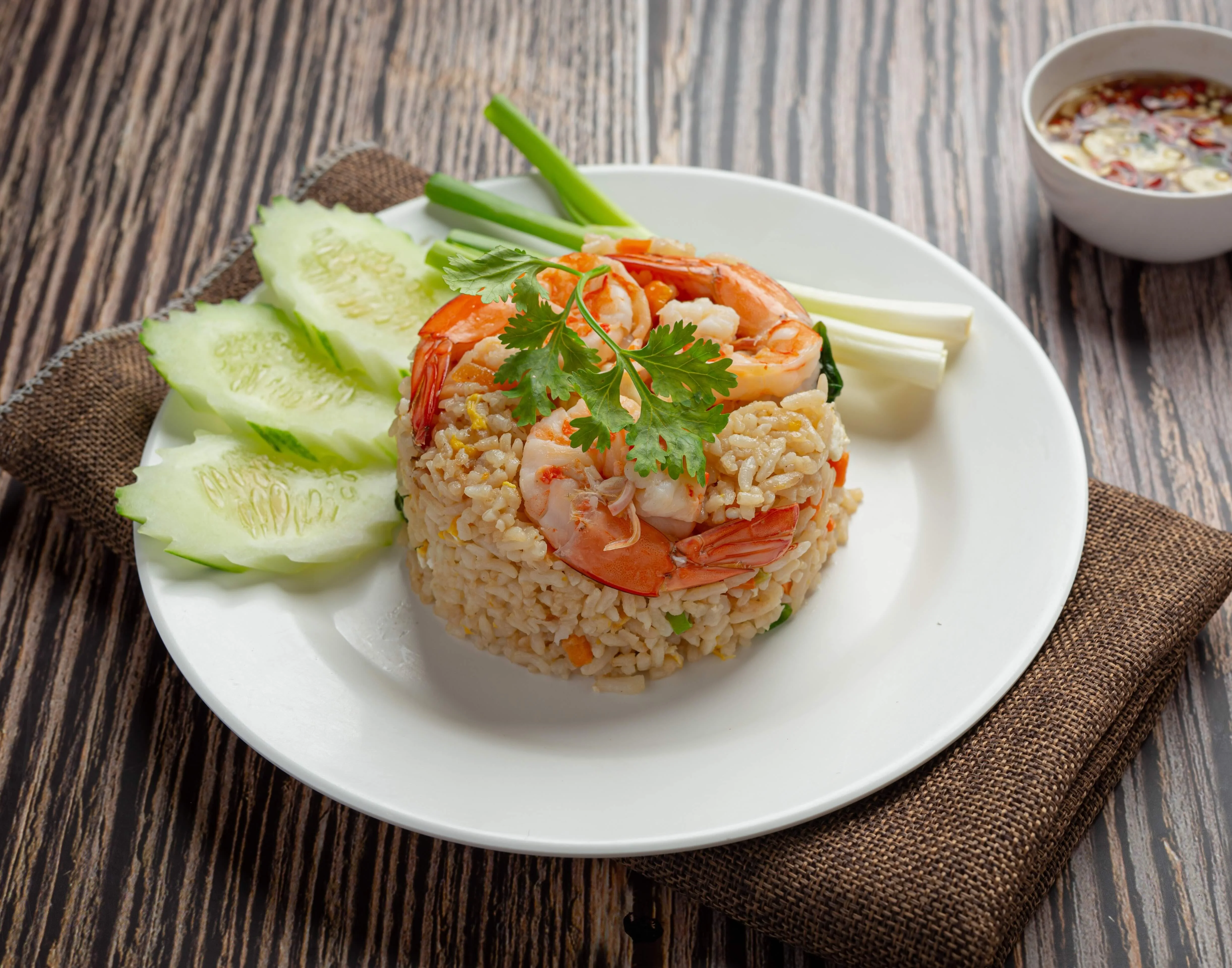 Shrimp fried rice served with cucumber and dipping sauce