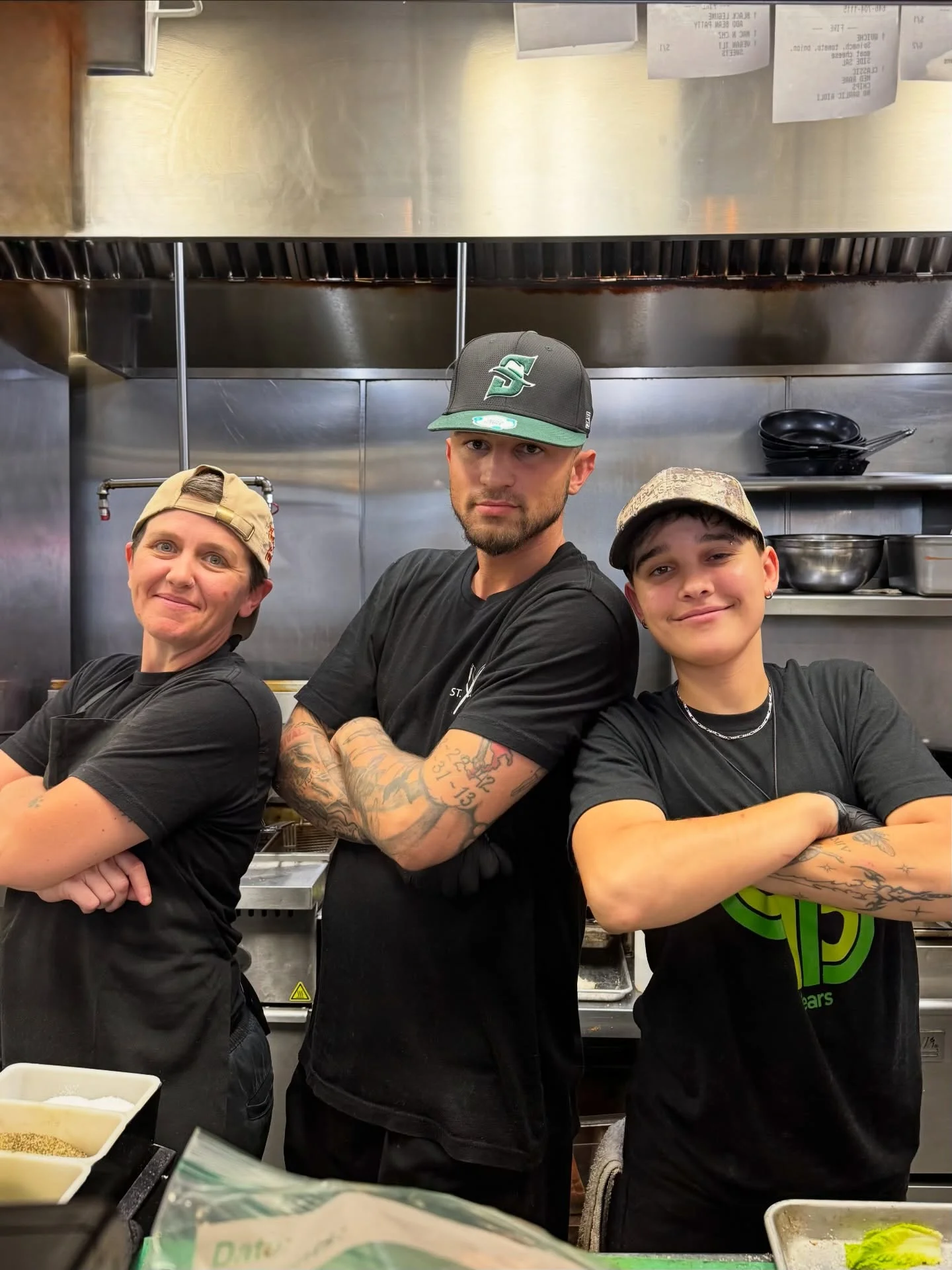 Culinary team posing confidently in a restaurant kitchen