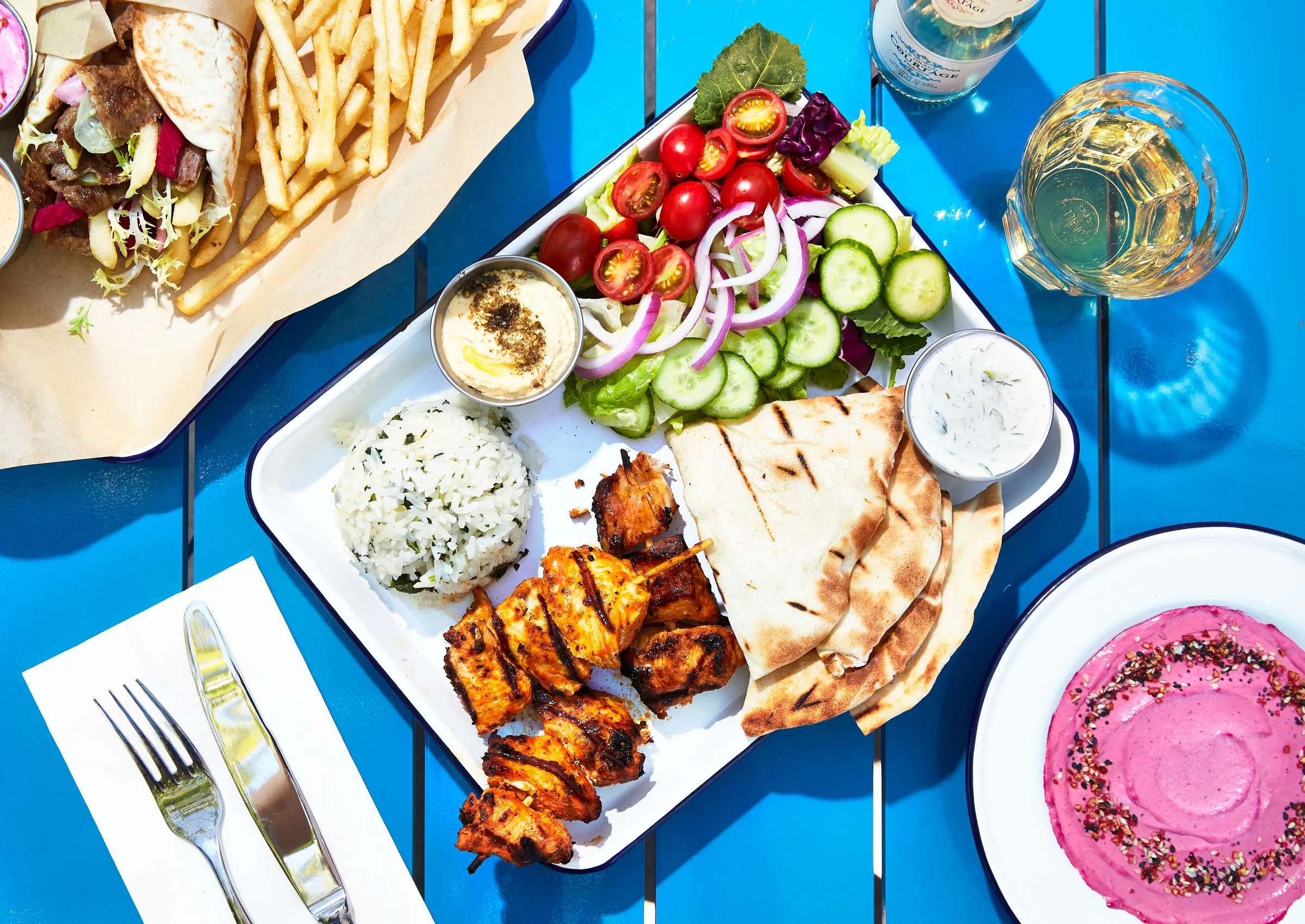 Mediterranean chicken kebab platter with rice and fresh salad