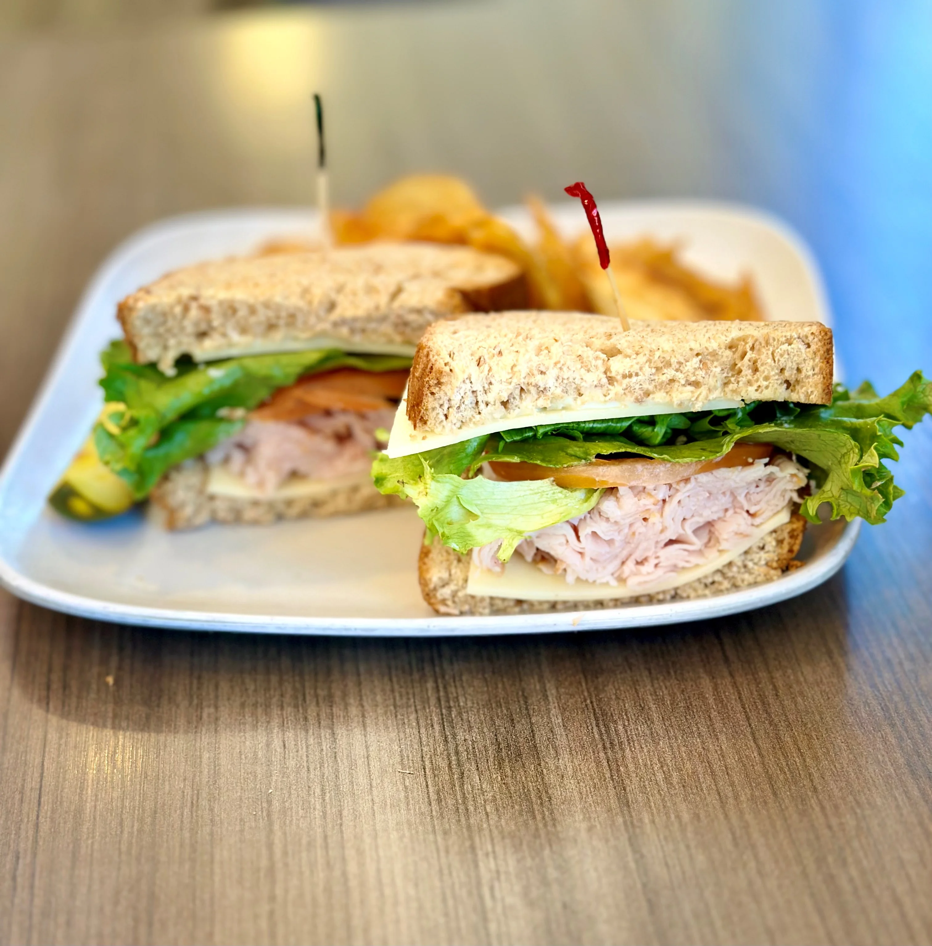 Turkey sandwich on whole grain bread with fresh greens