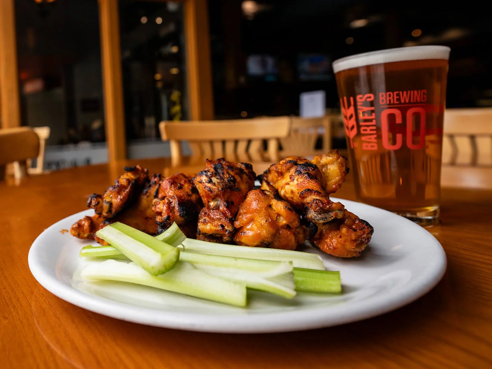Delicious wings served with dipping sauces on a wooden table.