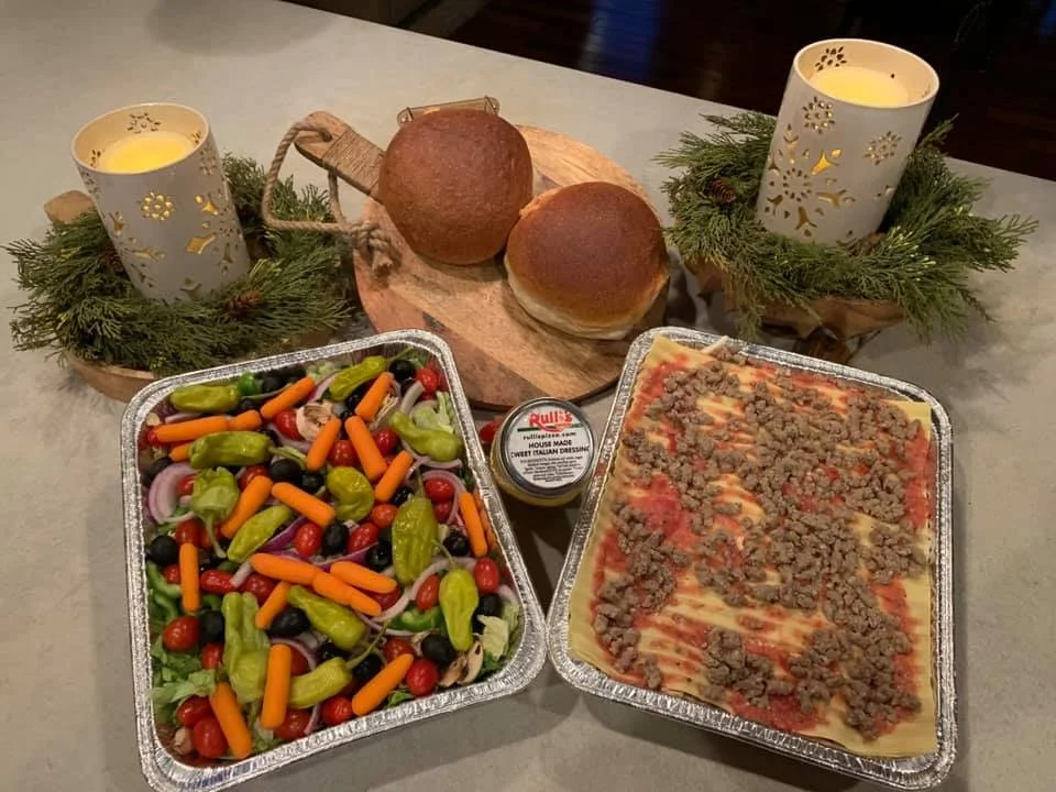 Delicious family-style meal served on a wooden table.