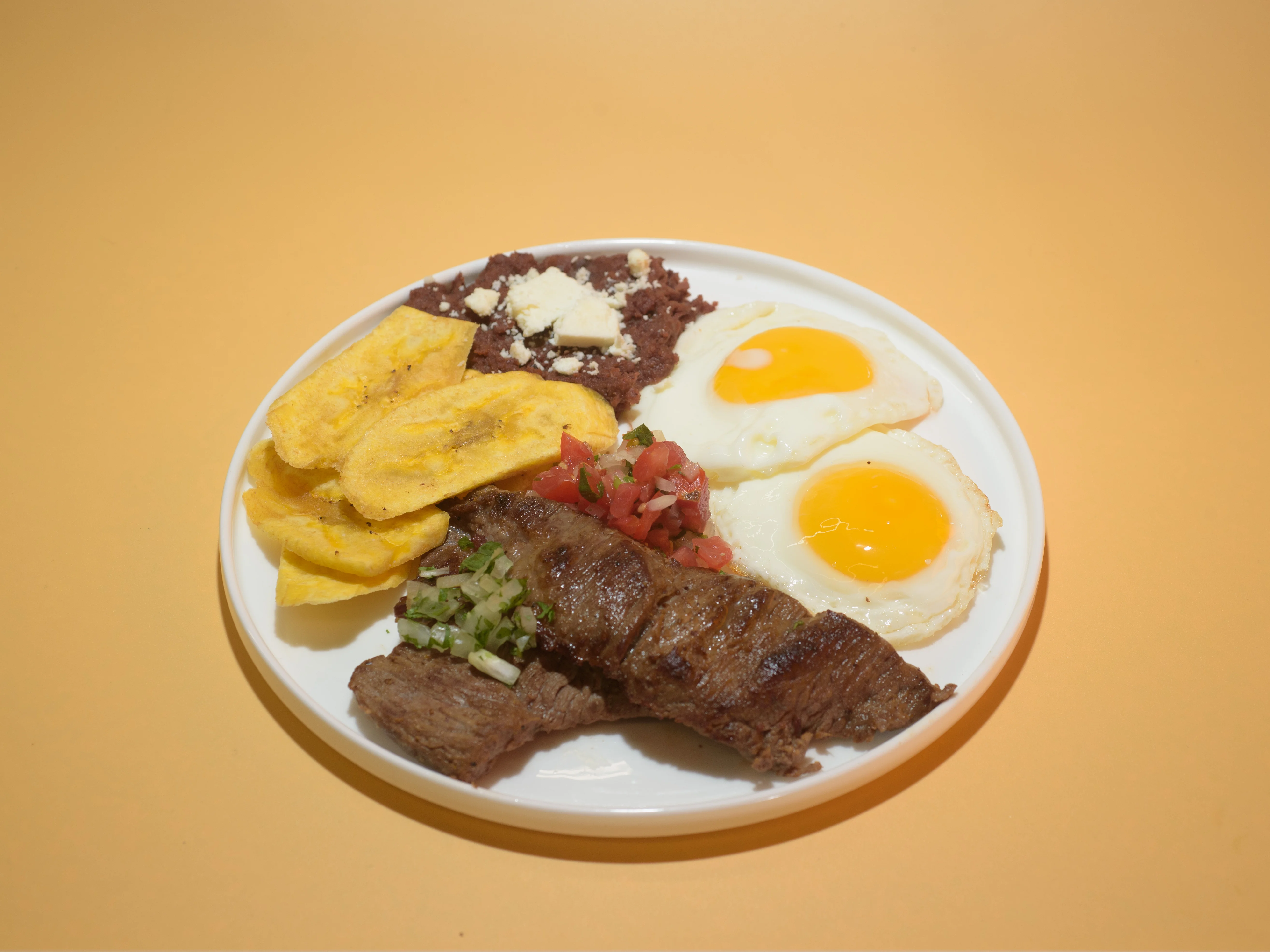 Traditional Colombian bandeja paisa with steak and eggs