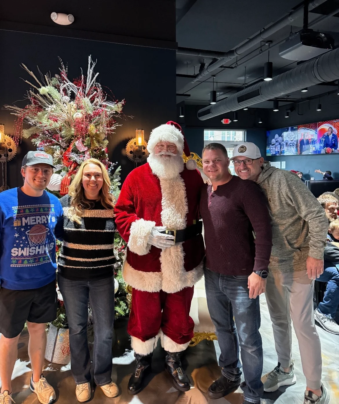 Group photo with Santa Claus in a festive restaurant setting