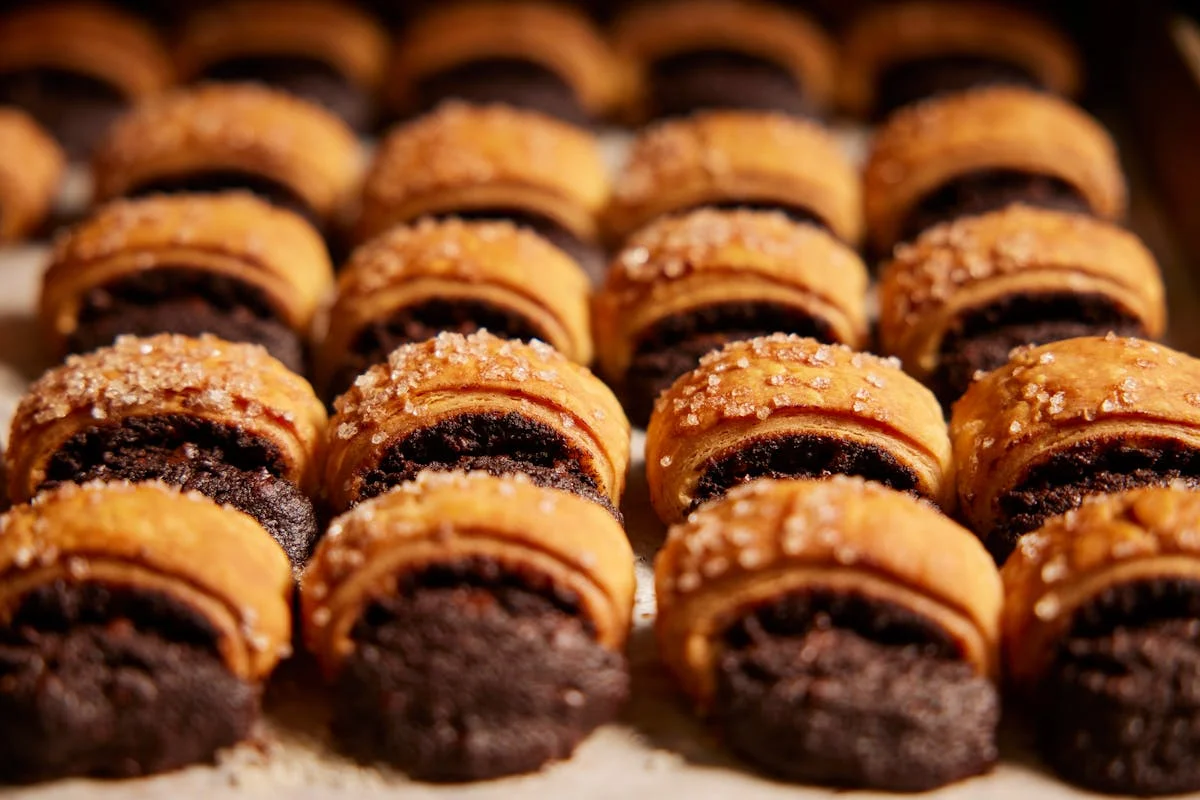 Freshly baked chocolate rugelach pastries with sugar topping