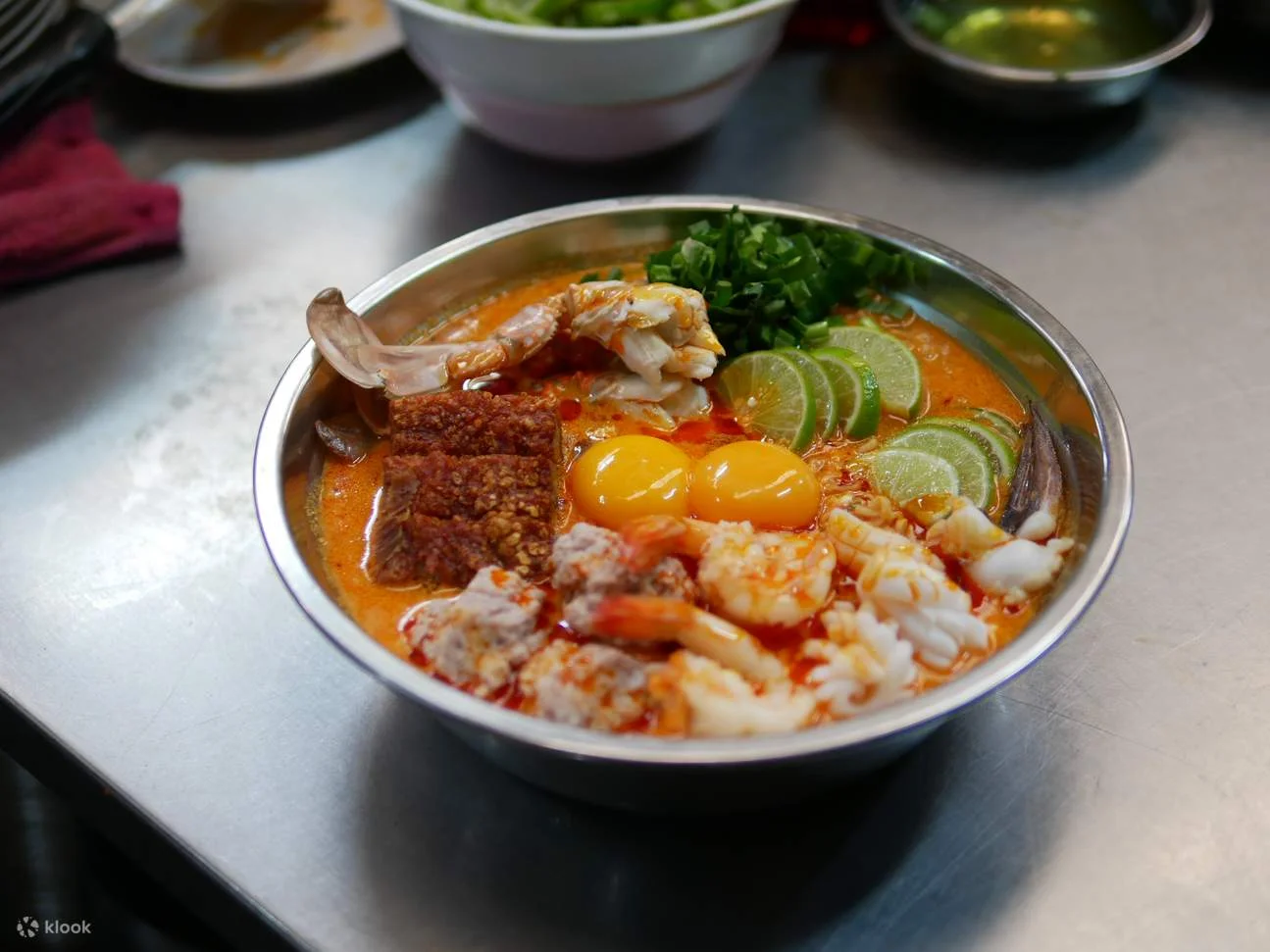 Spicy Thai tom yum seafood soup with fresh herbs
