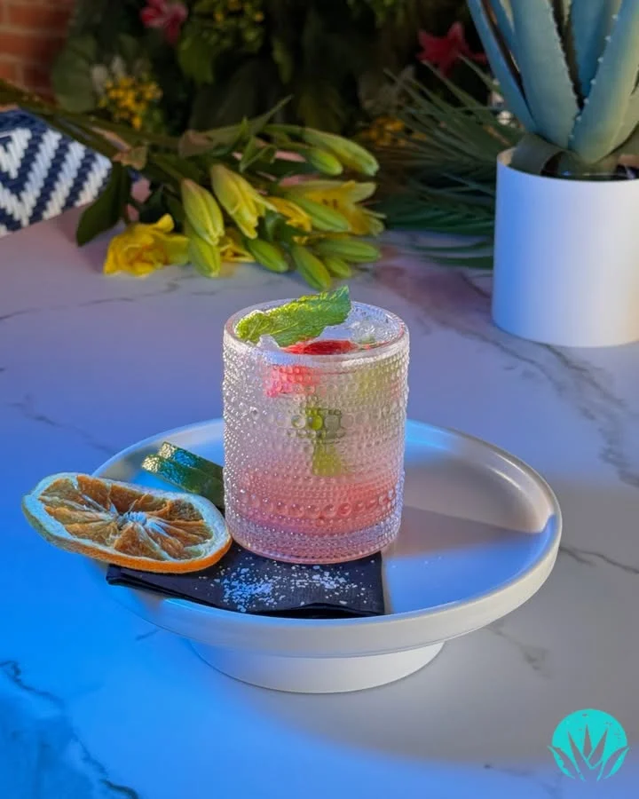 Refreshing cocktail garnished with mint and citrus on a stylish plate