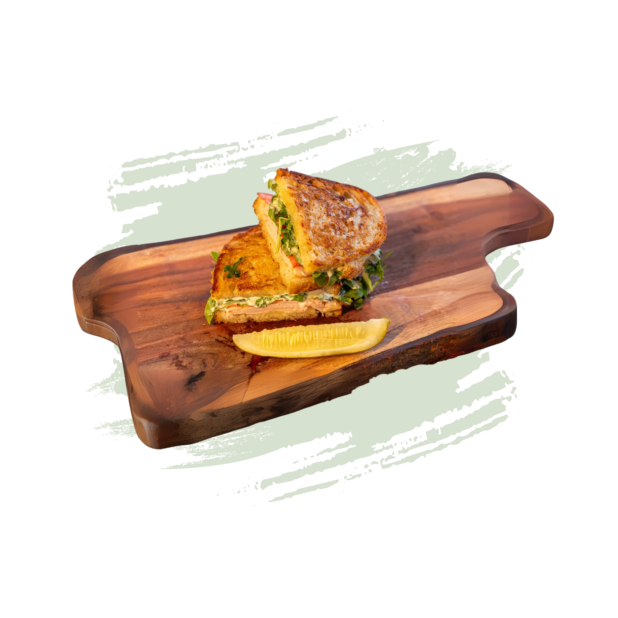 Grilled cheese sandwich with fresh greens on a wooden board