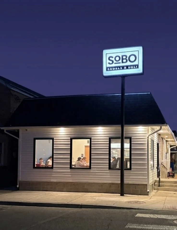 Exterior view of SOBO restaurant at night with illuminated sign