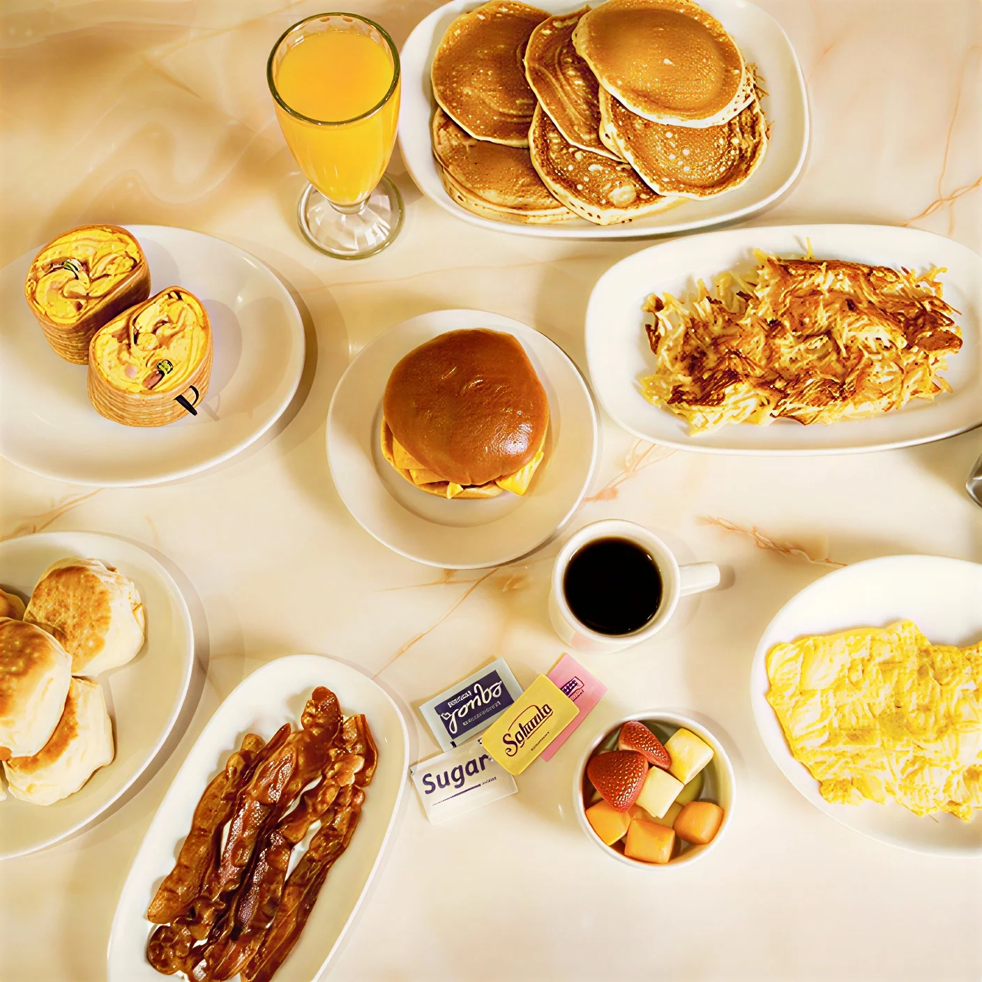 Moonlite Diner breakfast spread featuring pancakes, eggs, crispy bacon, biscuits, hash browns, coffee, fresh fruit, orange juice, and classic American breakfast favorites.