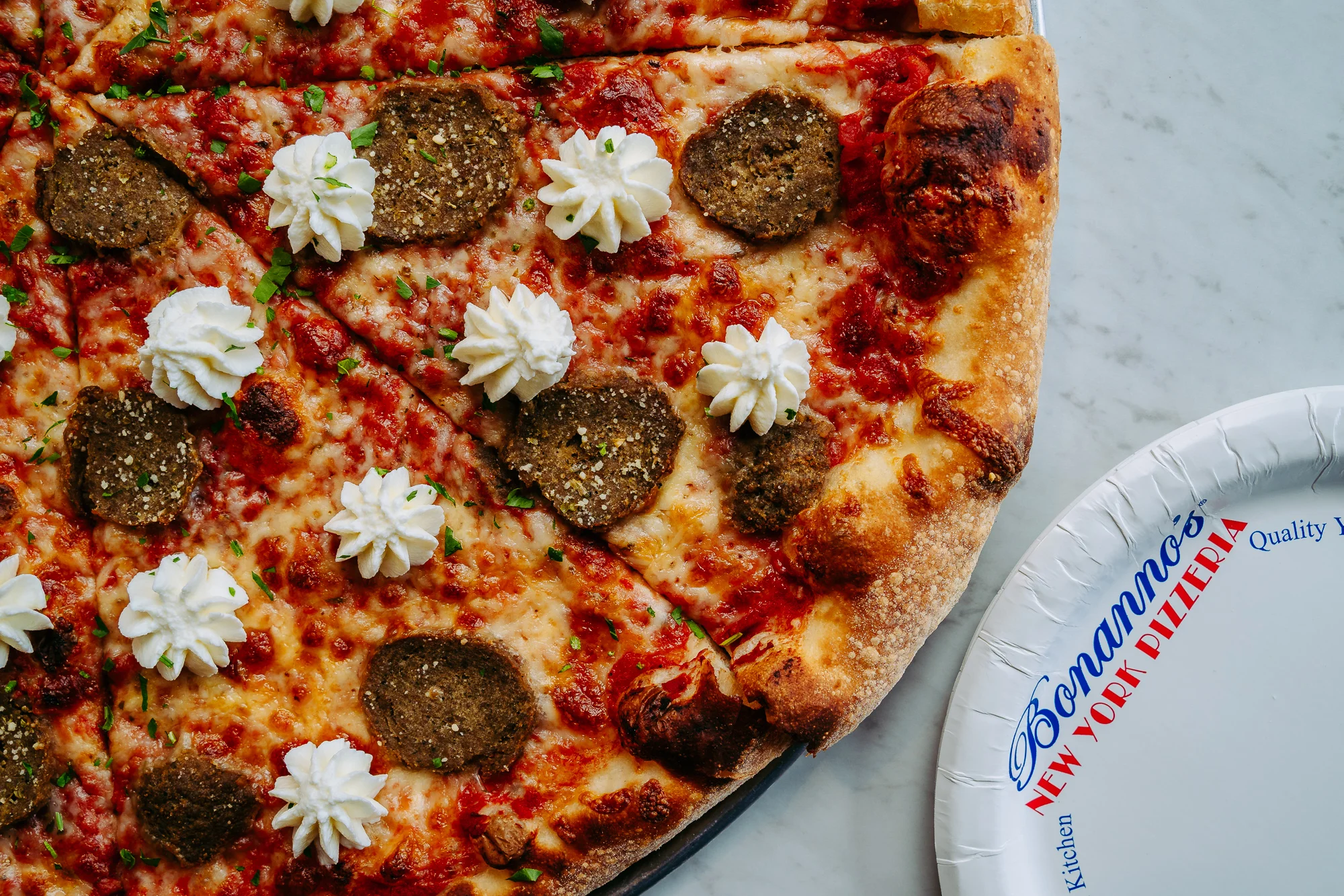 Unique pizza topped with meatballs and whipped cream
