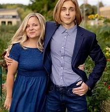 Couple posing in a flower garden with vibrant blooms