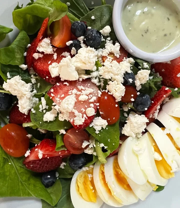 Fresh spinach salad with strawberries and hard-boiled eggs
