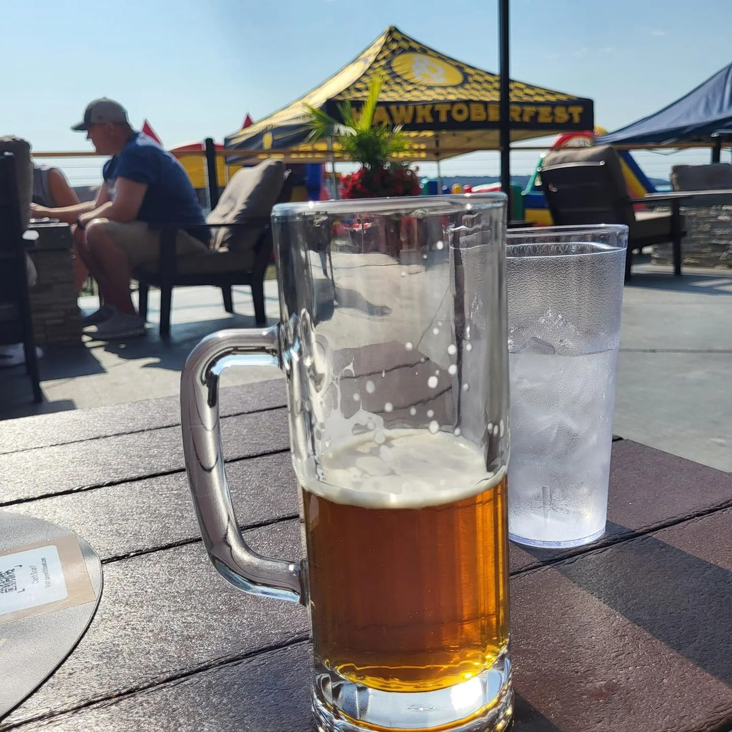 Refreshing beer on a sunny patio with festive decorations