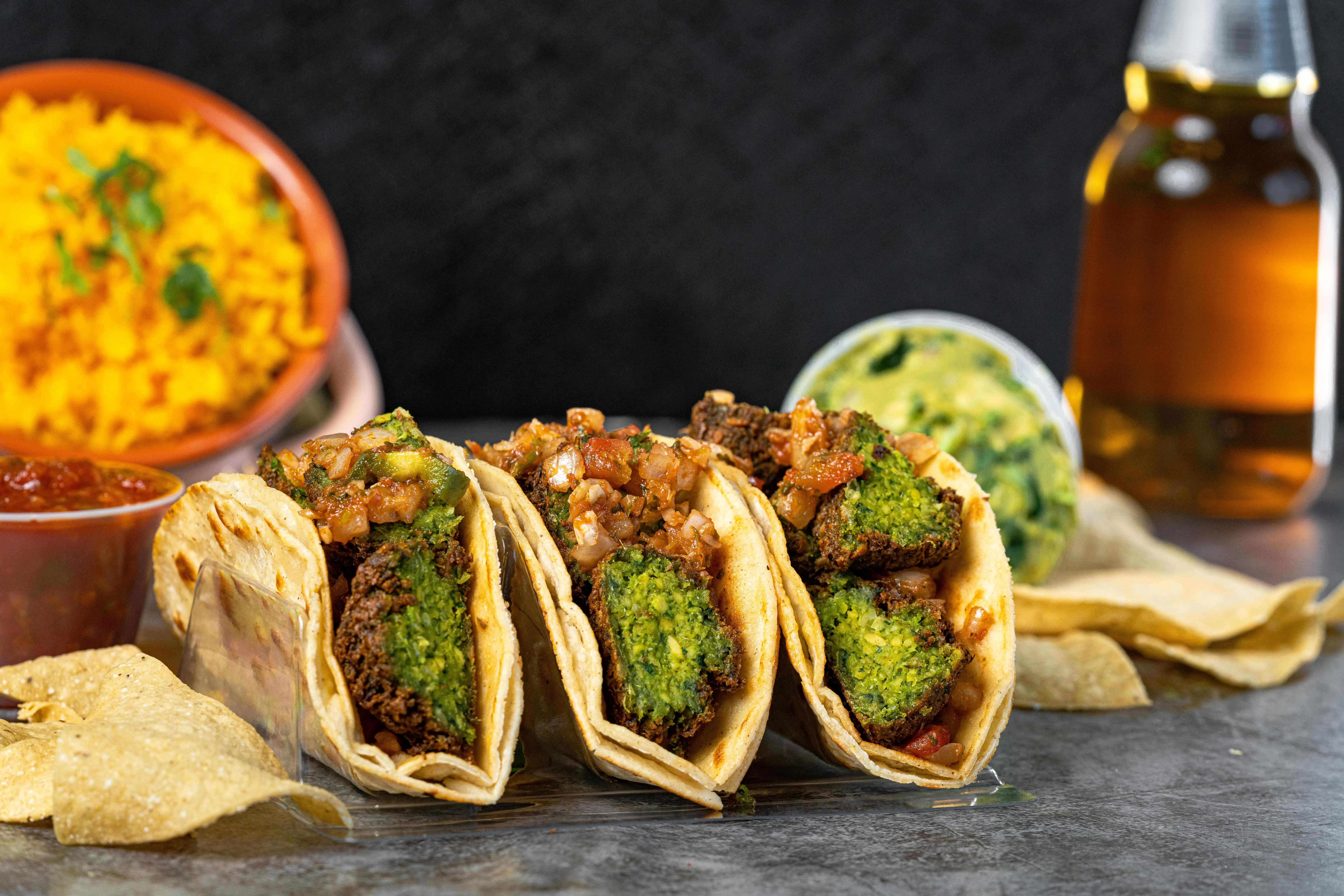 Authentic East Coast street tacos with crispy falafel, fresh pico de gallo, and soft corn tortillas, served with salsa, guacamole, rice, and chips. A must-try Brooklyn taco experience blending Latin and Mediterranean flavors