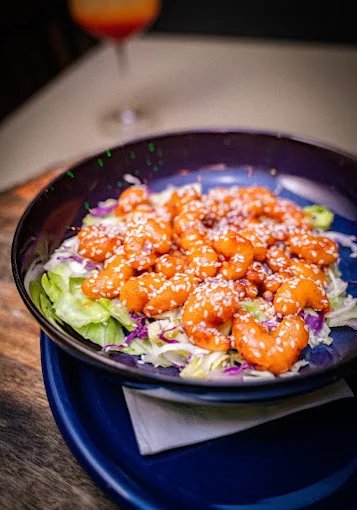 Crispy orange shrimp salad with sesame seeds