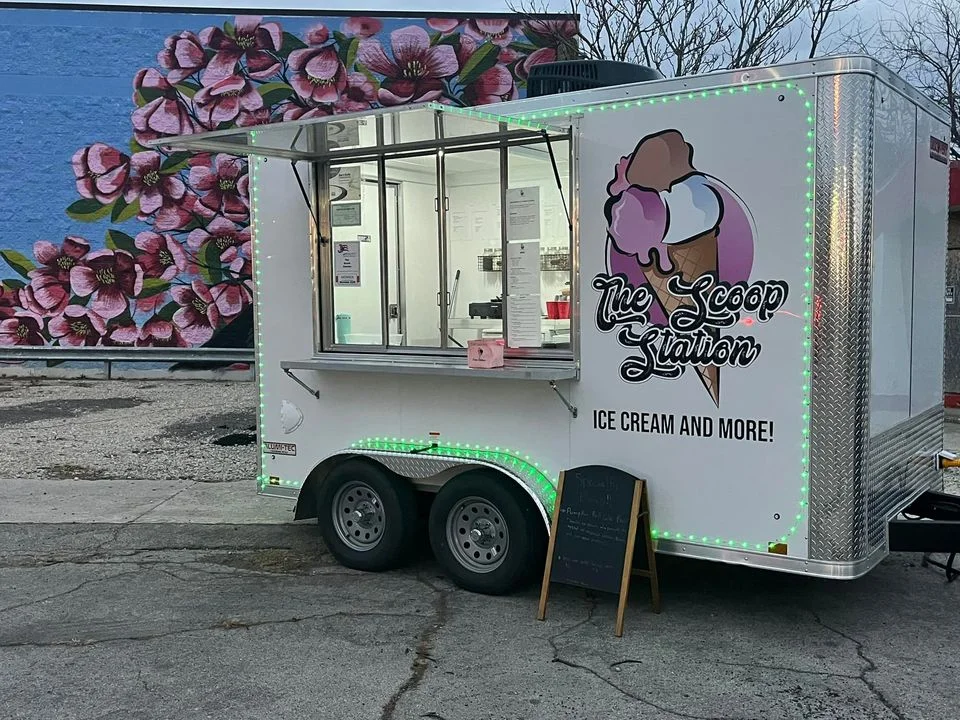 Ice cream truck with vibrant branding and menu display